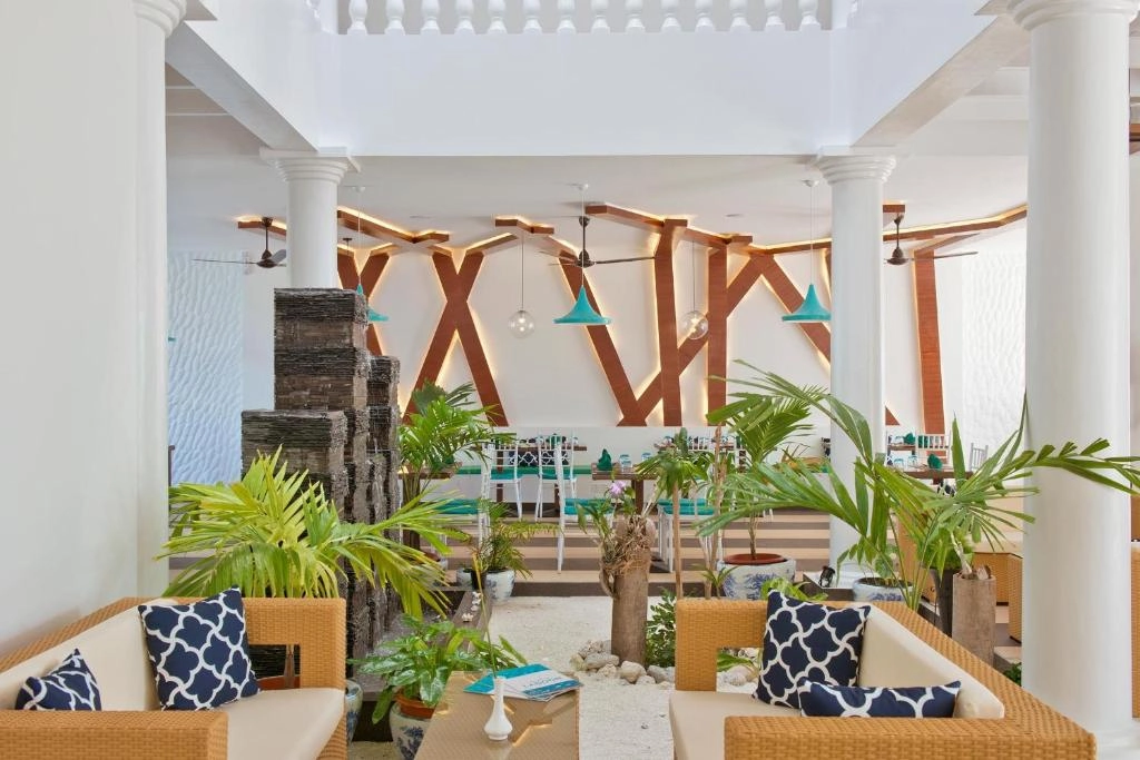 Crystal Sands lobby with tropical plants and lounge seating