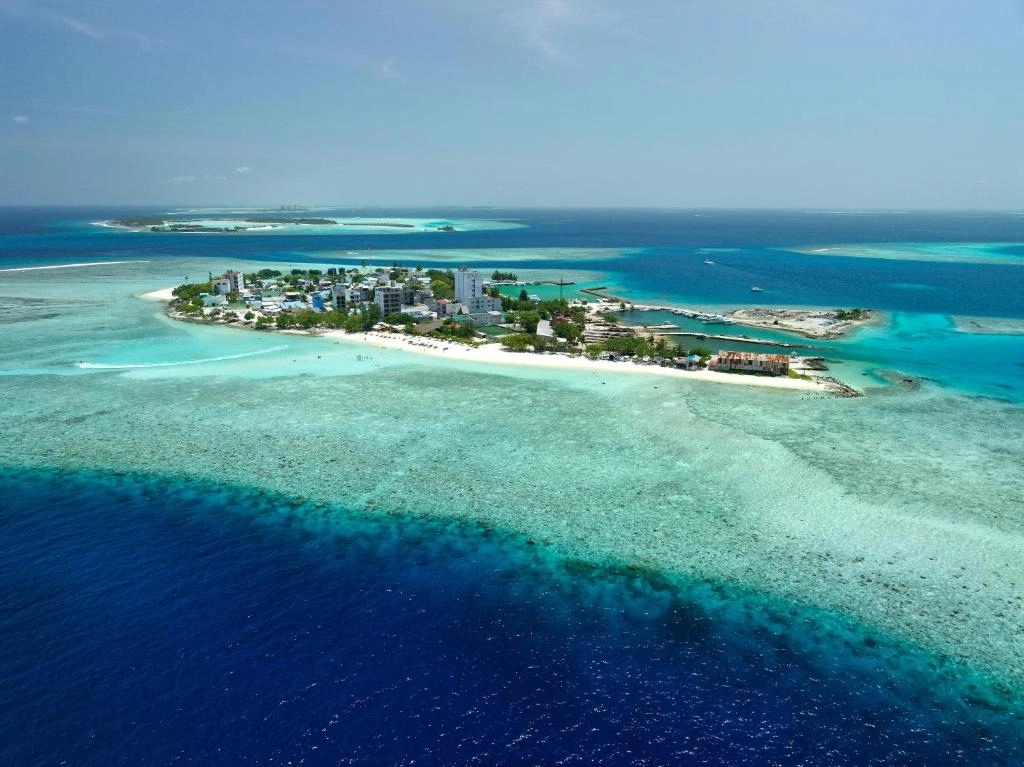 Aerial view of Maafushi Island surrounded by turquoise Maldives waters